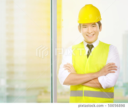 Asian worker man in safety vest and yellow helmet 50056898