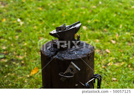 A hammer on an anvil. The tool uses a blacksmith in a blacksmith shop A hammer on an anvil. The tool uses a blacksmith in a blacksmith shop 50057125