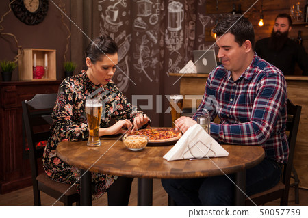 Lovely couple in new pub enjoying their beer. Lovely couple in new pub enjoying their beer. 50057759