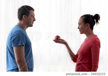 Woman gives apple to man Woman gives apple to man 50058155