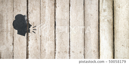 Speaking female silhouette on wooden background Speaking female silhouette on wooden background 50058179