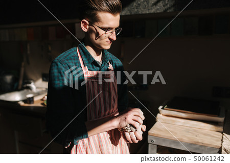 Male potter works with clay. Hand's of man creating ceramic product 50061242