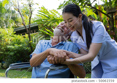 senior man happiness sitting on wheelchair with 50061559