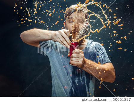 Man drinking a cola and enjoying the spray. Man drinking a cola and enjoying the spray. 50061837