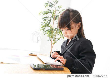Business woman doing desk work in office Business woman doing desk work in office 50062233