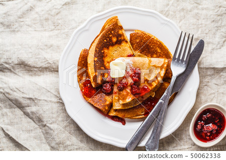 Crepes with raspberry jam and butter 50062338