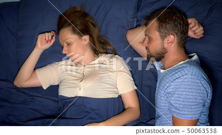concept of problems in a pair. sexual problems. couple, displeased man and woman are lying in bed concept of problems in a pair. sexual problems. couple, displeased man and woman are lying in bed 50063538