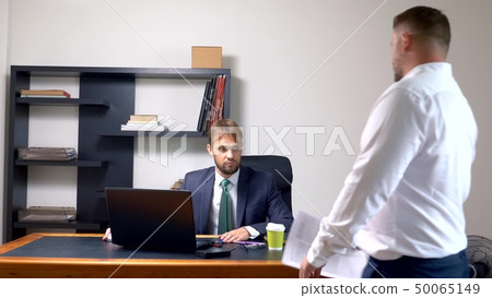 manager in the office. the employee who received the notice, a letter or a document with unexpected 50065149