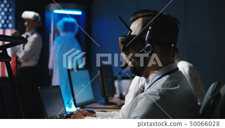 Technician working at his desk Technician working at his desk 50066028
