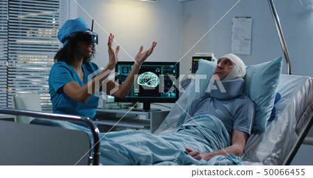 Doctor using VR headset during discussing diagnosis Doctor using VR headset during discussing diagnosis 50066455