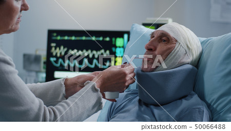 Wife feeding husband in hospital Wife feeding husband in hospital 50066488