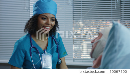 Doctor showing brain scan image to patient Doctor showing brain scan image to patient 50067500