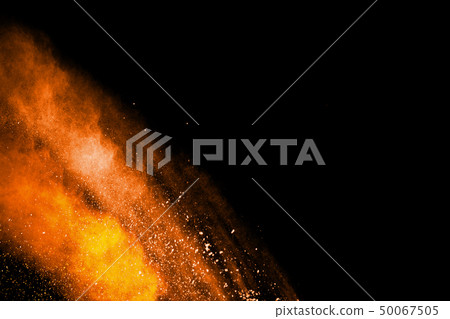 Orange powder explosion on black background. 50067505
