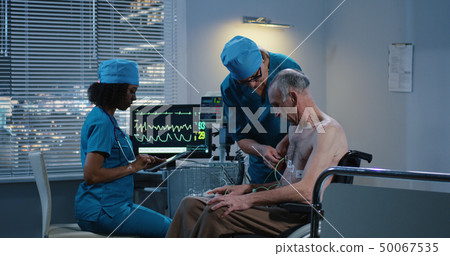 Female doctor checking patients heart rate 50067535
