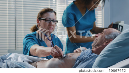 Doctor using stethoscope in hospital 50067652