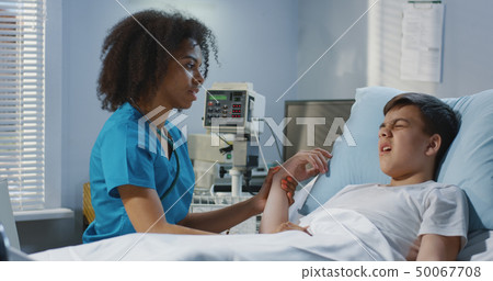 Female doctor visiting teenager patient Female doctor visiting teenager patient 50067708