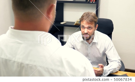 manager in the office. the employee who received the notice, a letter or a document with unexpected manager in the office. the employee who received the notice, a letter or a document with unexpected 50067834
