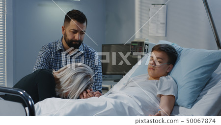 Teenager boy lying in hospital Teenager boy lying in hospital 50067874