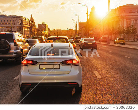 Cars are in a city traffic during a beautiful golden sunset in a Moscow. Cars are in a city traffic during a beautiful golden sunset in a Moscow. 50068320