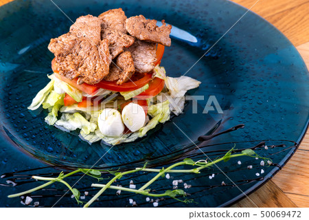 Italian food background. Mozzarella cheese, fresh basil leaves, tomatoes, olive oil, meat on the Italian food background. Mozzarella cheese, fresh basil leaves, tomatoes, olive oil, meat on the 50069472