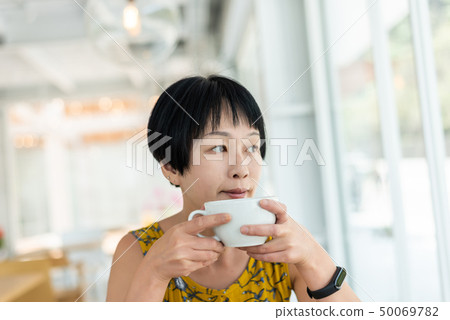 Asian woman hold a cup of coffee 50069782