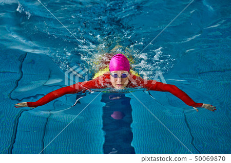 Female athlete in a red-yellow swimsuit is 50069870