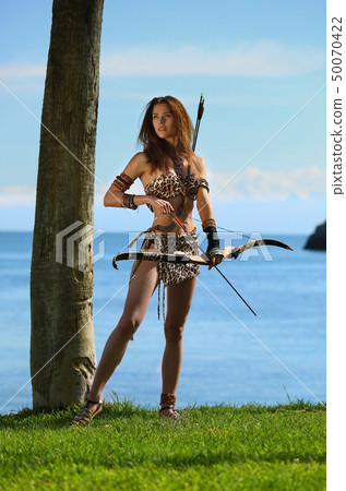 A young beautiful girl with a bow and arrows A young beautiful girl with a bow and arrows 50070422