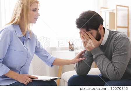 Depressed man crying at psychotherapy in despair 50070843
