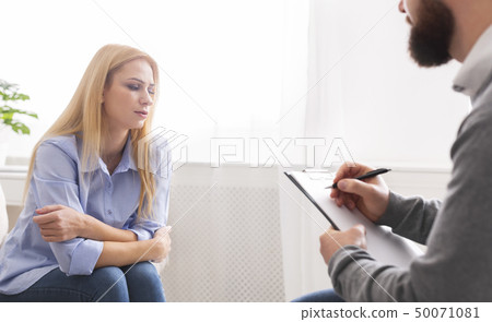 Depressed millennial woman sharing her problems with psychologist 50071081