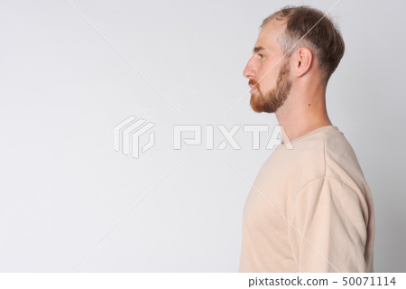 Closeup profile view of young bearded man Closeup profile view of young bearded man 50071114