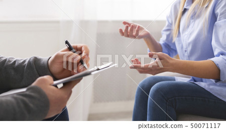 Emotional woman sharing her troubles and gesturing at psychotherapy Emotional woman sharing her troubles and gesturing at psychotherapy 50071117