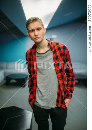 Male teenager in cinema hall before the showtime 50072002