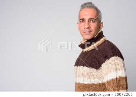 Profile view of handsome Persian man looking at camera ready for winter 50072205