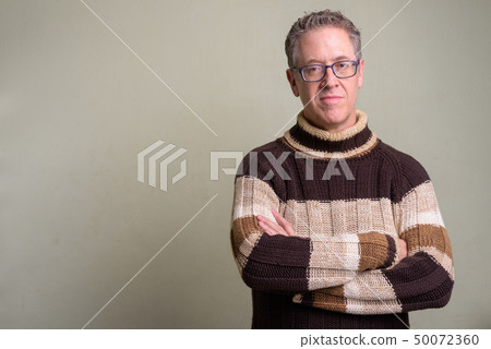 Mature man wearing turtleneck sweater and eyeglasses Mature man wearing turtleneck sweater and eyeglasses 50072360