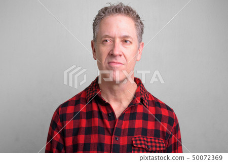 Mature hipster man wearing red checkered shirt Mature hipster man wearing red checkered shirt 50072369
