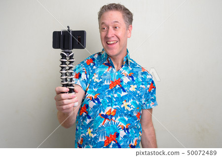 Portrait of mature tourist man ready for vacation Portrait of mature tourist man ready for vacation 50072489