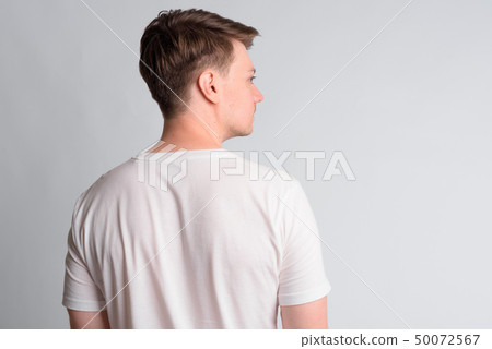 Rear view of young handsome man looking to the side Rear view of young handsome man looking to the side 50072567