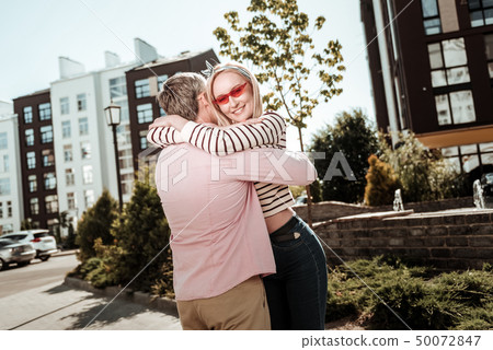 Beautiful happy couple standing together in the neighborhood 50072847