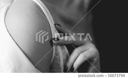 Hands of woman undressing white bra Hands of woman undressing white bra 50073799