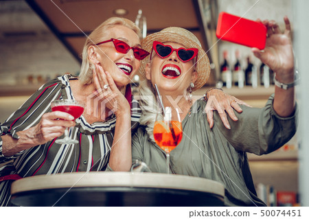 Positive happy women posing for a selfie 50074451