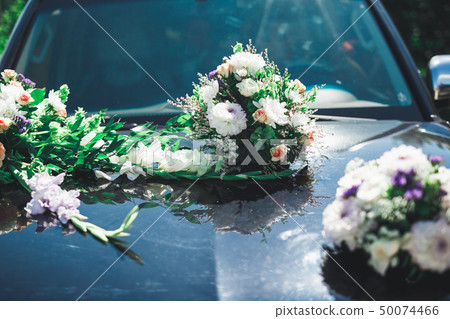 Wedding car decorated with beautiful, luxury flowers 50074466