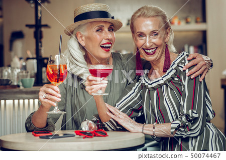 Delighted stylish aged women meeting in the restaurant 50074467