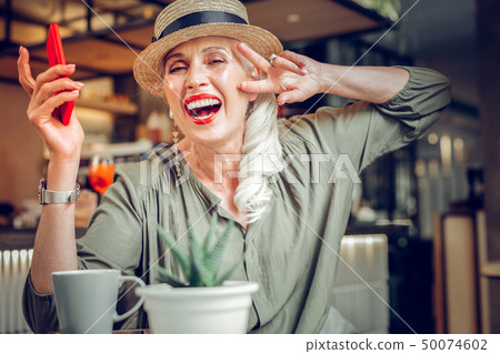 Delighted good looking woman showing her positive emotions Delighted good looking woman showing her positive emotions 50074602