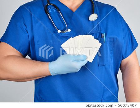 doctor in sterile latex gloves and blue uniform doctor in sterile latex gloves and blue uniform 50075407