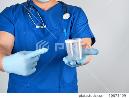 doctor in blue uniform and latex gloves  50075409