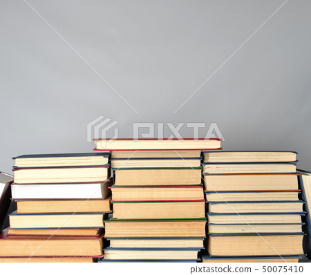 stack of different books on a gray background stack of different books on a gray background 50075410