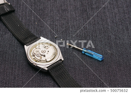 Closeup machine watch using as a background or wal 50075632