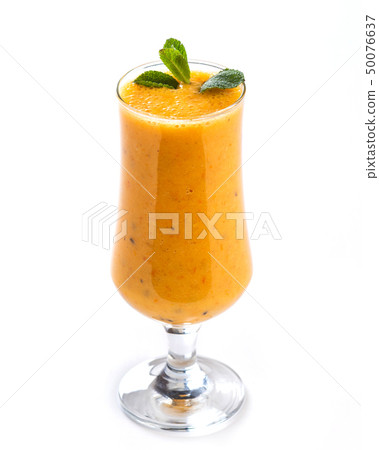 Orange smoothie in a tall glass decorated with a Orange smoothie in a tall glass decorated with a 50076637