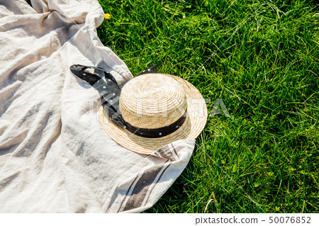 Cloth and hat on picnic on meadow. Cloth and hat on picnic on meadow. 50076852
