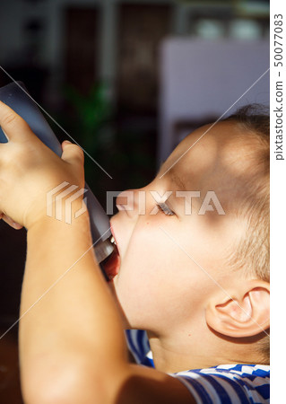 Little boy is drinking chocolate topping in Thailand Little boy is drinking chocolate topping in Thailand 50077083
